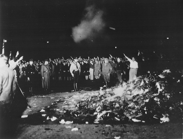 University students display the Nazi salute as thousands of books burn in Berlin in 1933. The *Gleichschaltung* ('coordination') of the country included raids and public burnings of books deemed 'degenerate,' mostly related to sexual education but also those by Jewish, socialist, liberal, or pacifist authors. Later, bans and new textbook guidelines sought to limit and control the educational materials available to Germans. History education was censored, especially in the lower grades.